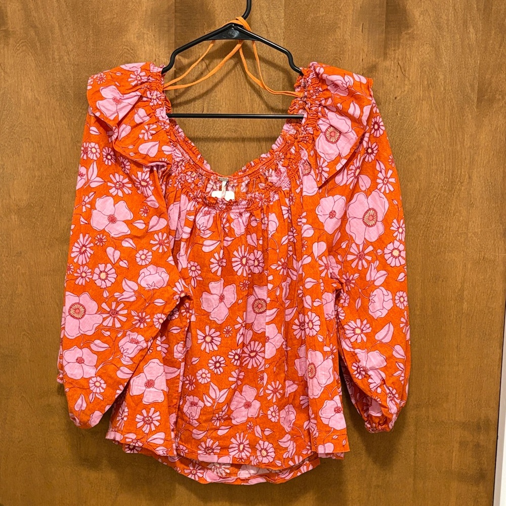 371. Free People Pink Floral Blouse on Orange Background